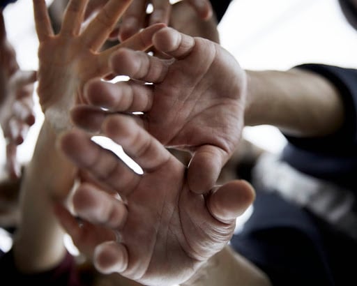A diverse group of individuals extending their hands out, symbolizing the variation of cluster B personality disorders.