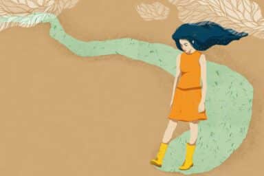 A woman in an orange dress strolls gracefully along a scenic path surrounded by greenery as she is coping with depression.