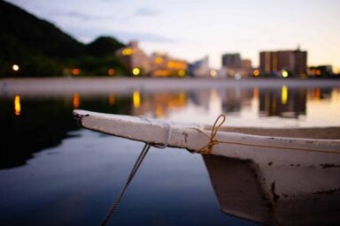 A boat tied to a dock, gently floating on the calm water, depicting the symptoms of early-onset Alzheimer's.