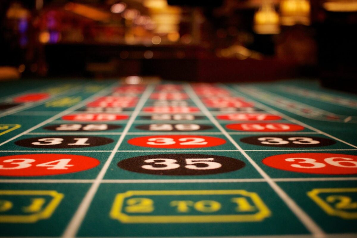 A roulette table at a casino, displaying colorful numbers, illustrating the problem of gambling addiction.