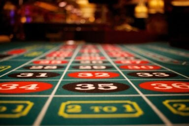 A roulette table at a casino, displaying colorful numbers, illustrating the problem of gambling addiction.